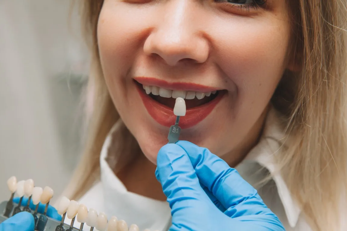 Dr. Tran reviewing crown and veneer options with a patient in Huntington Beach