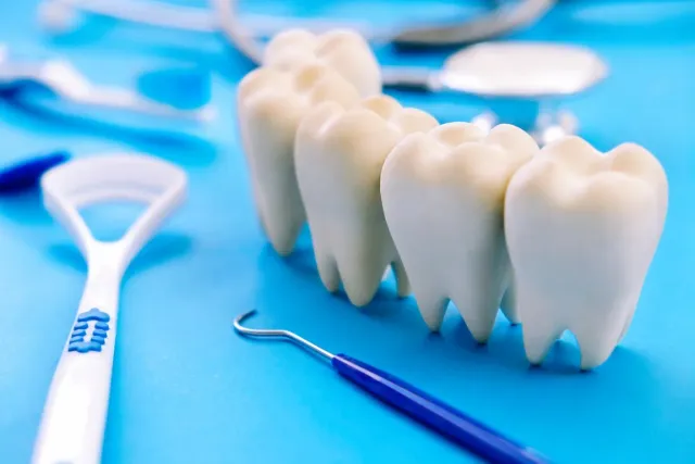 Tooth extraction site being examined for dry socket at Peninsula Dentistry in Huntington Beach