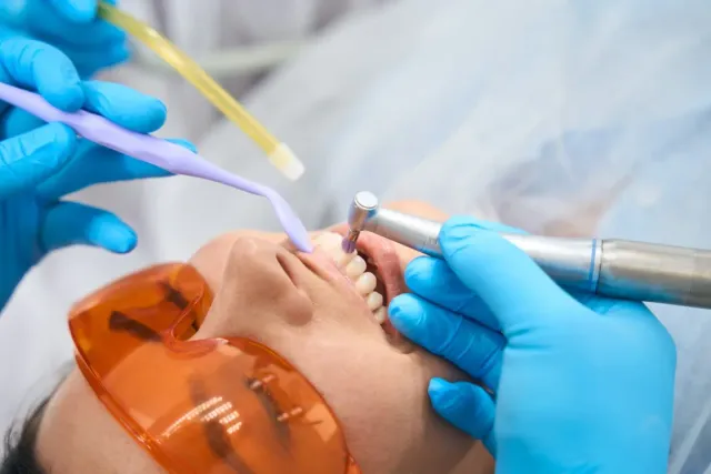 Patient receiving a professional dental cleaning and exam at Peninsula Dentistry in Huntington Beach