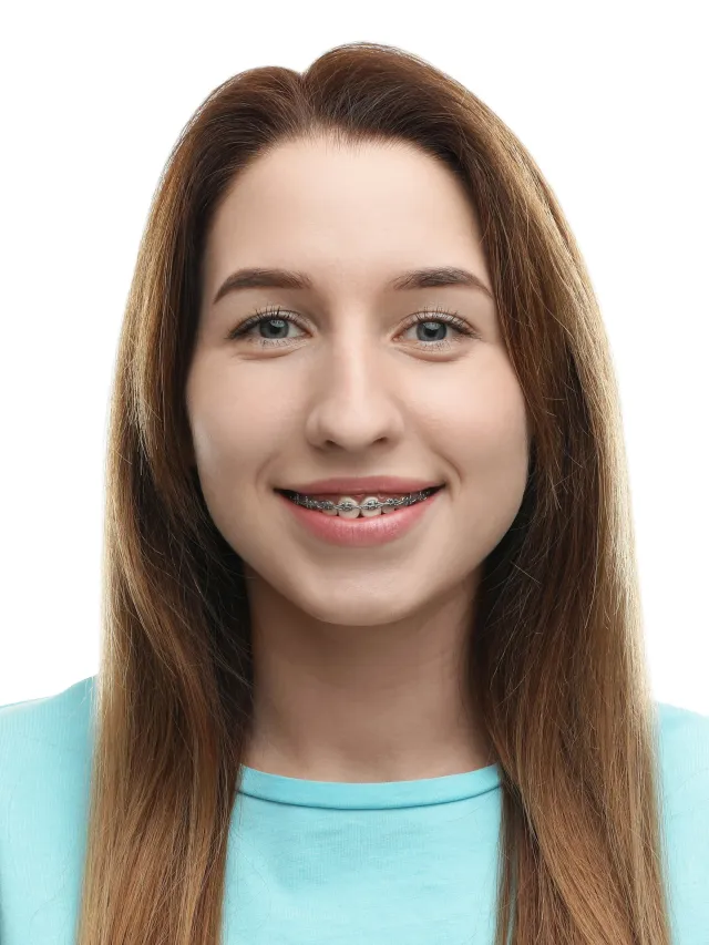 Teenage girl smiling confidently with metal braces showing positive orthodontic treatment results