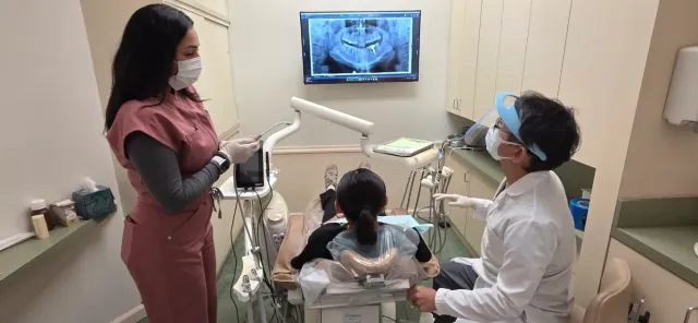 Dr. Tran and a dental assistant caring for a patient
