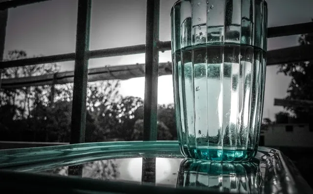 Clear glass of water — hydration is essential for managing dry mouth